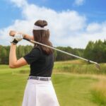 Woman,Golfer,Hits,An,Fairway,Shot,Towards,The,Club,House